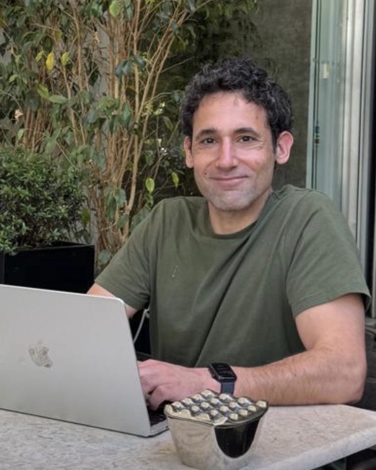 Roy, working at a laptop outdoors